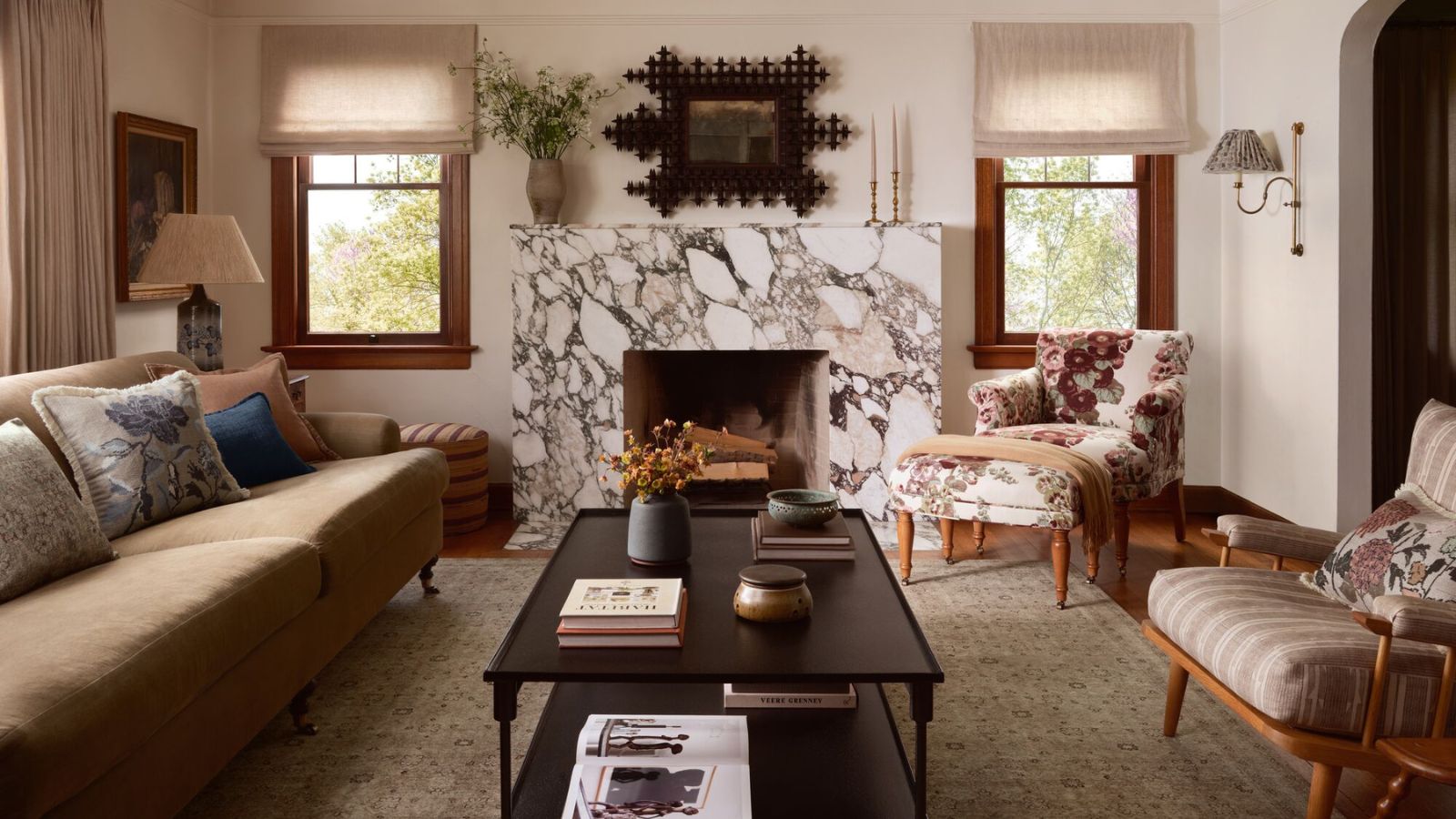 Cozy living room corner with a warm lamp, blanket, and open book at dusk